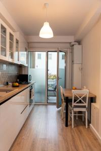 a kitchen with a table and a dining room at Vanguard Suite De Lux in Craiova