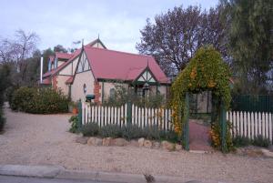a small house with a white picket fence at The Dove Cote in Tanunda