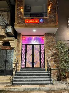 a front door of a building with a stained glass window at Al FAHAD private apartments for rent in Luxor