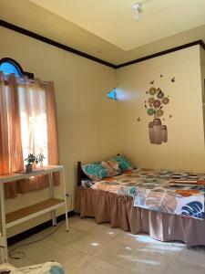 a bedroom with a bed and a window at Subangan Veranda1, Burgos Central location in Burgos