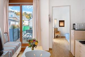 a living room with a couch and a balcony at Haus Stiegeler - Gottfried Beck in Freiburg im Breisgau