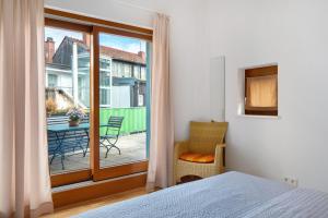 a bedroom with a bed and a balcony with a table and chairs at Haus Stiegeler - Gottfried Beck in Freiburg im Breisgau