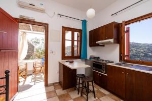 a kitchen with wooden cabinets and a table and a window at Motivo in Kastron