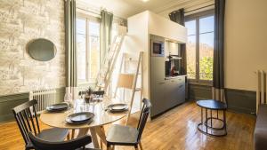 comedor con mesa, sillas y escalera en BonAppart 13 - Charme Napoléonien & Confort, en Troyes