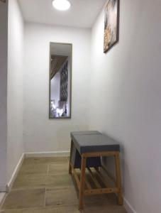 a room with a bench and a mirror on a wall at Idromasage room in Catania