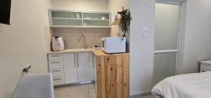 a kitchen with a sink and a microwave on a counter at GoldSea - Boutique Seafront Studio in Nahariyya
