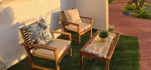 two chairs and a coffee table on a patio at GoldSea - Boutique Seafront Studio in Nahariyya