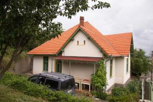 a small white house with an orange roof at Nostalgia in Turda