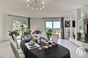 a dining room with a table with a black table cloth at La rose des vents in La Chèze