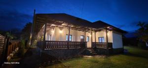 a small house with lights on the front of it at Casa LEO in Filioara