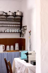 a kitchen with a table with a sewing machine on it at Koutsounari Traditional Cottages in Koutsounari
