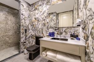 a bathroom with a sink and a toilet at Blue Sea Karpasia Hotel in Rizokarpaso +67 photos