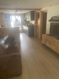 a living room with a couch and a flat screen tv at Chez Nico in Frans