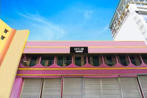 a building with a nike sign on the side of it at Super Hotel O Rishra Railway Station Formerly Green Guest House in Khardah +22 photos