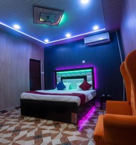 a bedroom with a bed with purple lighting at TRIP MY BUDDY Hotels in Varanasi