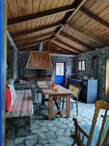 a kitchen with a wooden table in a room at Tommy's Guest House in Konitsa