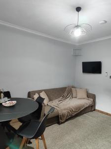 a living room with a couch and a table at Tommy's Guest House in Konitsa