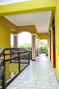 a balcony of a resort with yellow walls at Shamo Inn And Lounge Mukono in Mukono