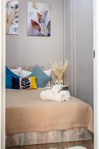 a bedroom with a bed with towels on it at Квартира в ЖК бизнес класса in Almaty