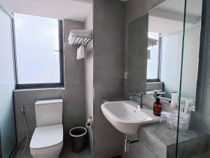 a bathroom with a toilet and a sink at The Guesthouse By SH in Phnom Penh