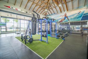 a gym with several tread machines and a large mural at 366 Ballito Hills in Ballito