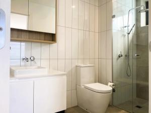 a bathroom with a toilet and a sink and a shower at MERCER APARMENTS 2 Bedroom Apartment with Bay Views on the Geelong Waterfront - 609 in Geelong +34 photos