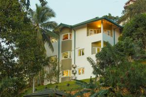 a white building with trees in front of it at Shalom Residence Kandy in Kandy