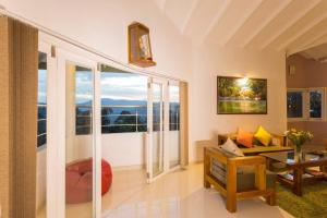 a living room with a view of the ocean at Shalom Residence Kandy in Kandy