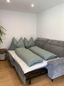 a couch with pillows on it in a living room at FamilienAppartement Waldstüberl in Kleinarl