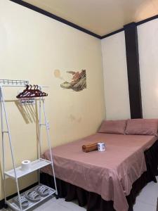a small room with a bed and a shelf at Subangan bayud3, Burgos central location in Burgos