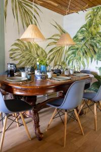 a dining room table with chairs and plants at Stilbjerg Sleep&Hygge in Varde