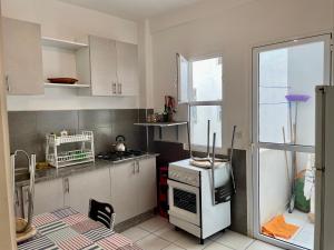 a kitchen with a white refrigerator and a stove at luxury apartment in fez in Oulad Akkou