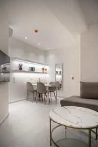 a living room with a table and a bed at Koukaki Urban Suites in Athens