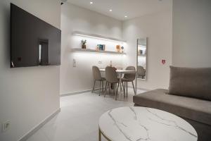 a living room with a couch and a table at Koukaki Urban Suites in Athens +51 photos