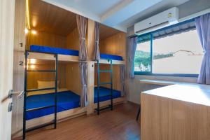 a bunk bed room with two bunk beds in it at Patong Poshtel in Patong Beach