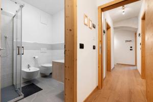 a bathroom with a shower and a toilet and a sink at Appartamento Saone in Ragoli +30 photos