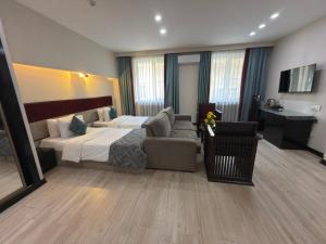 une chambre d'hôtel avec un lit et un canapé dans l'établissement Haz Boutique Hotel Baku, à Baku