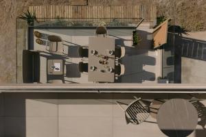 a rendering of a house from a window at Costel BeachFront Residence, BBQ & Private Sunbeds, By ThinkVilla in Fodele