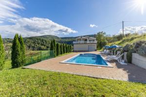 a backyard with a swimming pool and a house at Maria Buzet 1 with Shared Pool in Buzet +10 photos