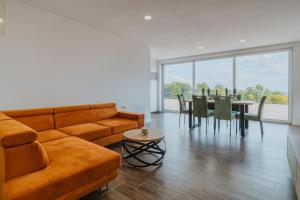 a living room with a couch and a table at Marmor Collis by Winery Glavica in Gornja Gračenica