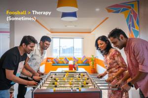 a group of people standing around a table with a chessboard at goSTOPS Bengaluru HSR, Silk Board in Bengaluru