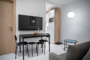 a living room with a black table and chairs at Koukaki Urban Suites in Athens