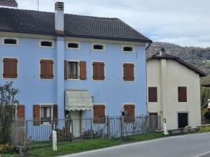 a white house with brown windows and a fence at Le 4 oche in Bastia