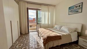 a bedroom with a large bed and a balcony at Mondello SunSea House in Mondello +51 photos