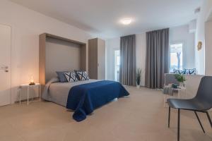 a bedroom with a bed with a blue bedspread at Villa Silvia in Montemaggiore al Metauro +56 photos