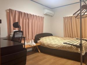 Postel nebo postele na pokoji v ubytování おかえりシェアハウス府中