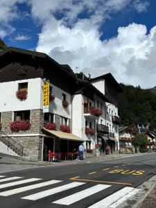a building on the side of a street with a crosswalk at Maen apartment, Valtournenche in Valtournenche
