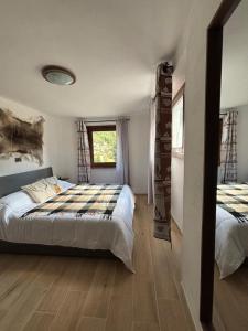 a bedroom with two beds and a window at Maen apartment, Valtournenche in Valtournenche