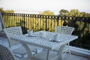 a white table and chairs on a balcony at Rodosto Hotel in Tekirdağ