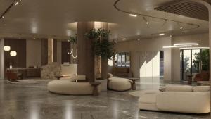 a lobby with couches and chairs in a building at Themis Beach Hotel in Kokkini Khanion